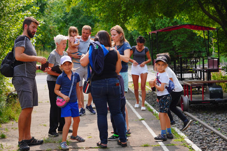 Poznan, Poland - July 27, 2023: People standing by a manual cart on rails.のeditorial素材