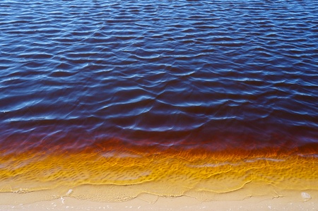 sandy bottom river bank yellow waterの写真素材