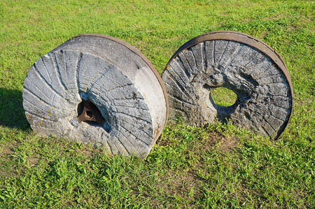 An ancient millstone were located on the grass in the natural backgroundの写真素材