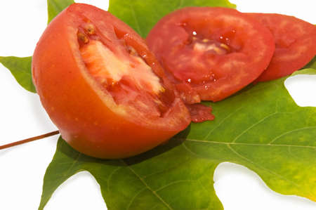 red tomatoes on green leaf as ingredient of saladの写真素材