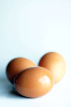 Three eggs on a light blue backgroundの写真素材