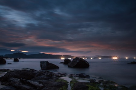 Lights of shrimp farming rigs in Vung Lam Bay Vietnam just after sunset looking over the south China sea.の写真素材