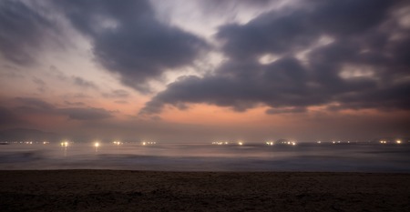 Lights of shrimp farming rigs in Vung Lam Bay Vietnam just before sunrise looking out over the south China sea.の写真素材