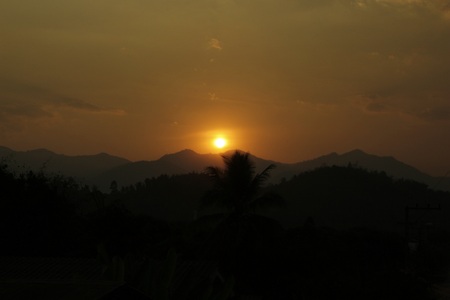 sunrise behind mountainsの写真素材