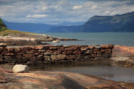 Beautiful nordic landscape, fiord with boat, glacier at the background. Shot in sunny beautifull day.の写真素材
