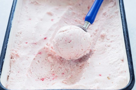 Raspberry ice cream. Balls of ice cream with raspberries and blueberries.の写真素材