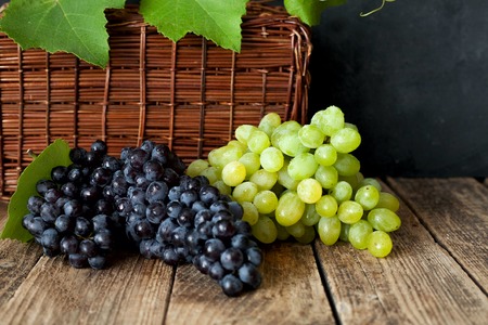 Grapes white and blue on a wooden backgroundの写真素材