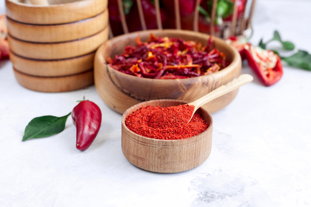 Homemade paprika spice on a spice background. Process paprika. Fresh bell pepper in dried and milled formの写真素材