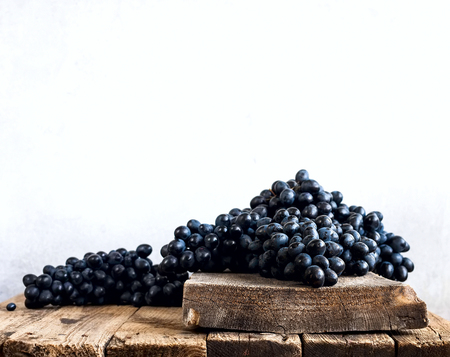 Bunches of ripe Blue grapes on wooden backgroundの写真素材