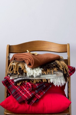 A stack of warm blankets on a chairの写真素材