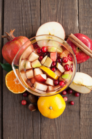 Sangria with apples, cranberries and orange in a bottleの写真素材