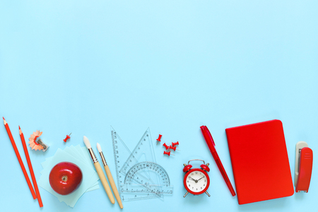 Blue background and red school supplies. To go back to school. Flat lay.の写真素材