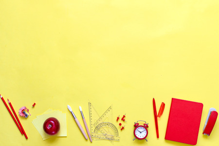 Yellow background and red school supplies. To go back to school.の写真素材