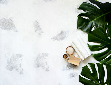 Spa and massage treatments on white, marble background monstera leaves. Flat lay. Top viewの写真素材