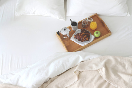 Morning Breakfast in bed. Coffee croissants, fresh orange juice. Copy space.の写真素材