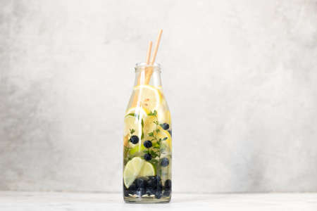 Detox water with lemon, blueberries, thyme and lime. Healthy drinks for health, energy and strength.の写真素材
