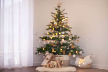 Christmas interior. The Christmas tree with gift boxes is blurry.の写真素材