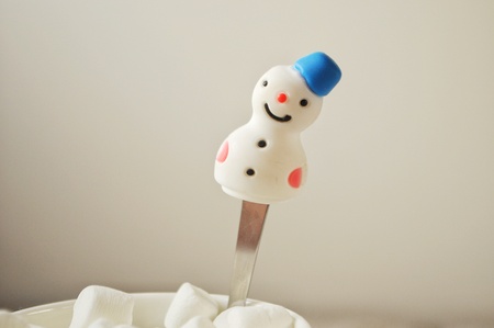 Snowman-spoon and marshmallow in cup of coffeeの写真素材