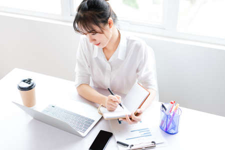 portrait of young businesswoman on white background
