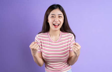 beautiful asian woman portrait, isolated on purple backgroundの写真素材