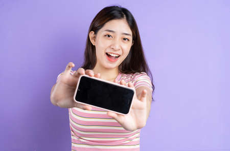beautiful asian woman portrait, isolated on purple background