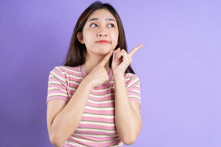 beautiful asian woman portrait, isolated on purple background