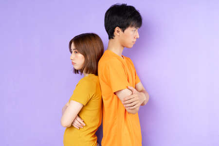 Asian couple portrait, isolated on purple backgroundの写真素材