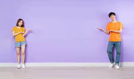 Asian couple portrait, isolated on purple backgroundの写真素材