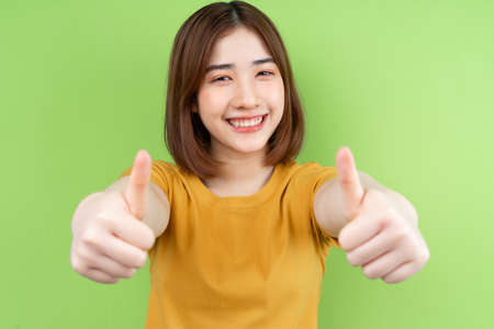 Young asian girl  posing on green background