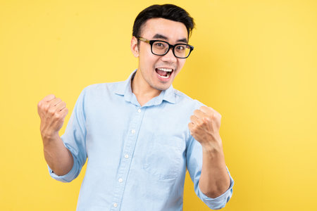 male portrait wearing shirt, isolated on yellow backgroundの写真素材