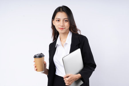 Portrait of young businesswoman wearing a suit, isolated on white backgroundの写真素材
