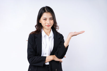 Portrait of young businesswoman wearing a suit, isolated on white backgroundの写真素材