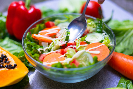 Healthy food choices to eat clean: fruits, vegetables, seeds, leafy vegetables on gray concrete