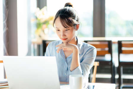 Portrait of Asian businesswoman working in a cafe