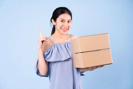 young asian girl image, isolated on blue background