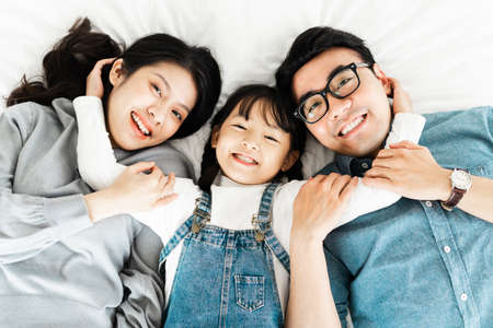 image of mother and daughter cuddling on the sofaの写真素材