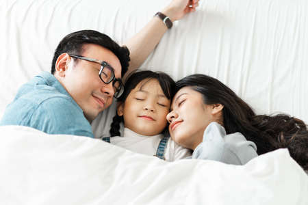 image of mother and daughter cuddling on the sofaの写真素材