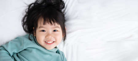 lovely baby girl portrait, isolated on blue backgroundの写真素材