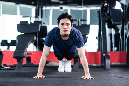 Image of Young asian businessman with glass building backgroundの写真素材