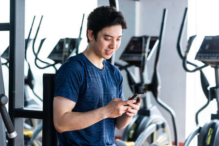 Image of Young asian businessman with glass building background