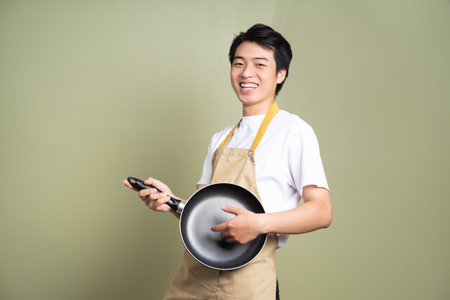 man holding a pan on the backgroundの写真素材