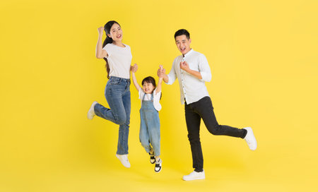 happy young asian family image, isolated on pink background