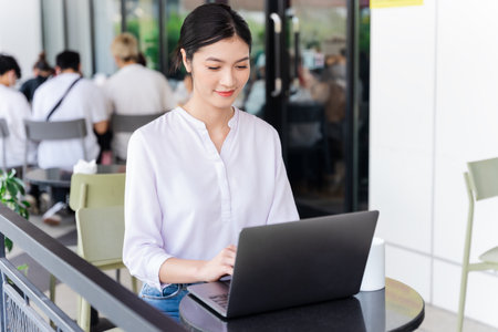 Portrait of beautiful asian woman sitting at cafeの写真素材