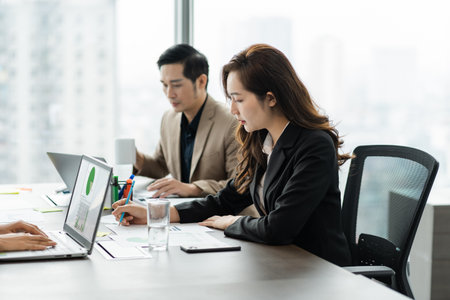 image of a group of Asian businessmen working together at the companyの写真素材