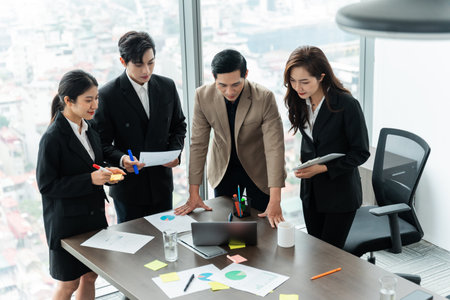 image of a group of Asian businessmen working together at the companyの写真素材