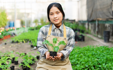 Asian female farmer portrait at vegetable gardenの写真素材