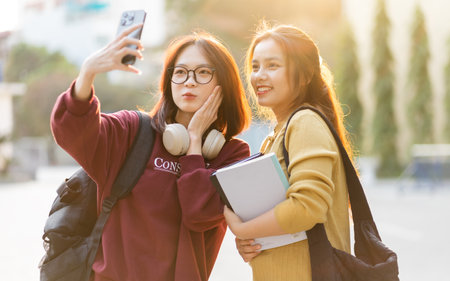 portrait of two beautiful Asian female college students at schoolの写真素材