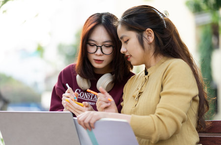 portrait of two beautiful Asian female college students at schoolの写真素材