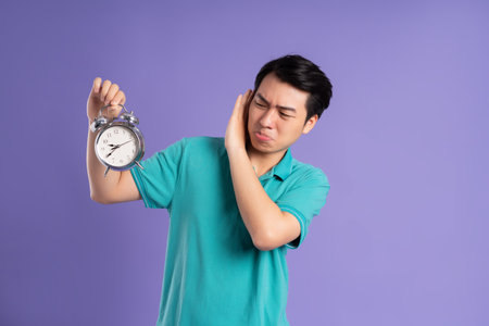 portrait of asian man posing on purple background