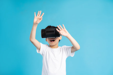 Asian boy portrait on blue backgroundの写真素材